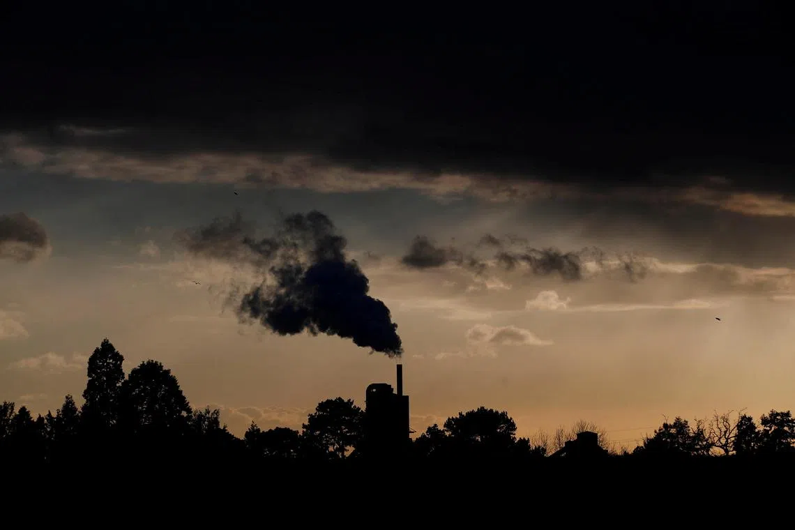 FILE PHOTO: Smoke rises above a factory at sunset in Rugby, Britain February 10, 2021. REUTERS/Matthew Childs/File Photo