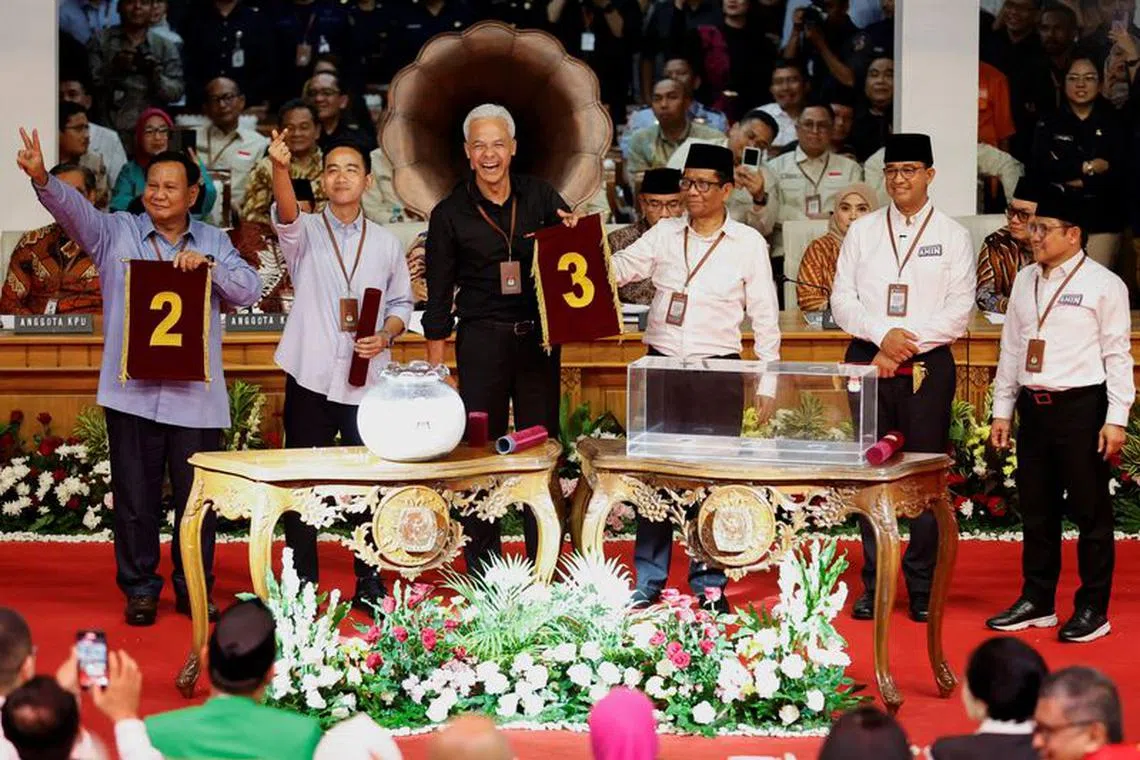 FILE PHOTO: Presidential candidates along with their running mates Prabowo Subianto, Gibran Rakabuming Raka, Ganjar Pranowo, Mahfud MD, Anies Baswedan, and Muhaimin Iskandar, hold their ballot numbers for next year's presidential elections, as they pose for a group photo during a ceremony at the election commission headquarters in Jakarta, Indonesia, November 14, 2023. REUTERS/Willy Kurniawan/File photo