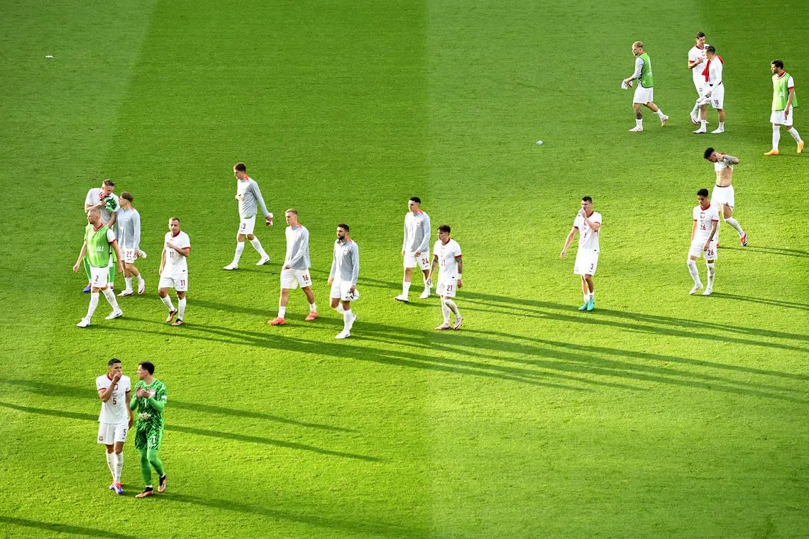 Soccer Football - Euro 2024 - Group D - Poland v Austria - Berlin Olympiastadion, Berlin, Germany - June 21, 2024 Poland players look dejected after the match REUTERS/Fabian Bimmer