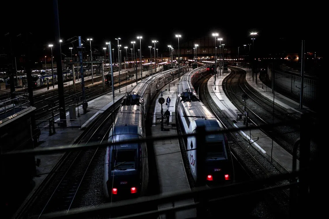 A man with a luggage walks on a platform between high-speed trains at the Gare de l'Est station in Paris on January 13. 
