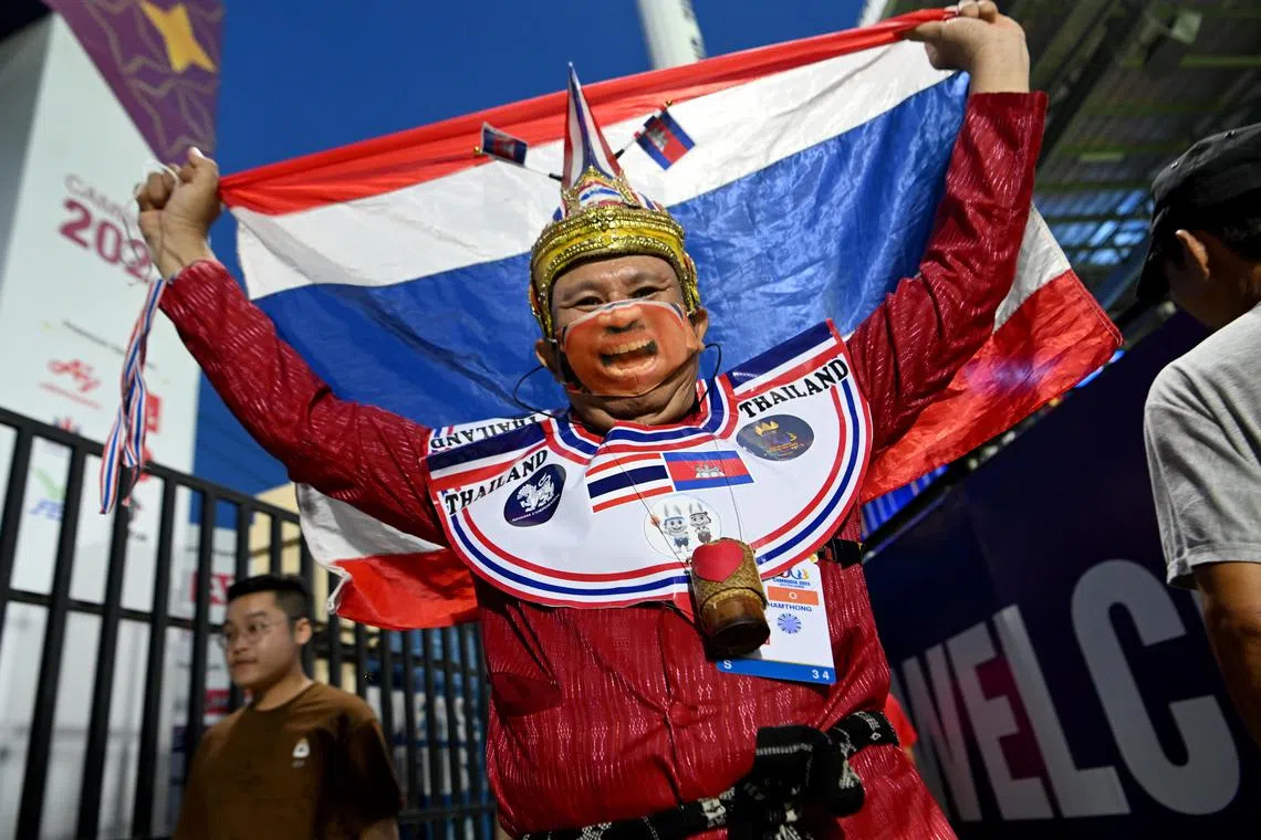 Thai football fan wearing a traditional head piece, celebrates after Thailand beat Singapore by 3-1 during the opening Group B match at the Prince Stadium in Phnom Penh, Cambodia on May 1, 2023.