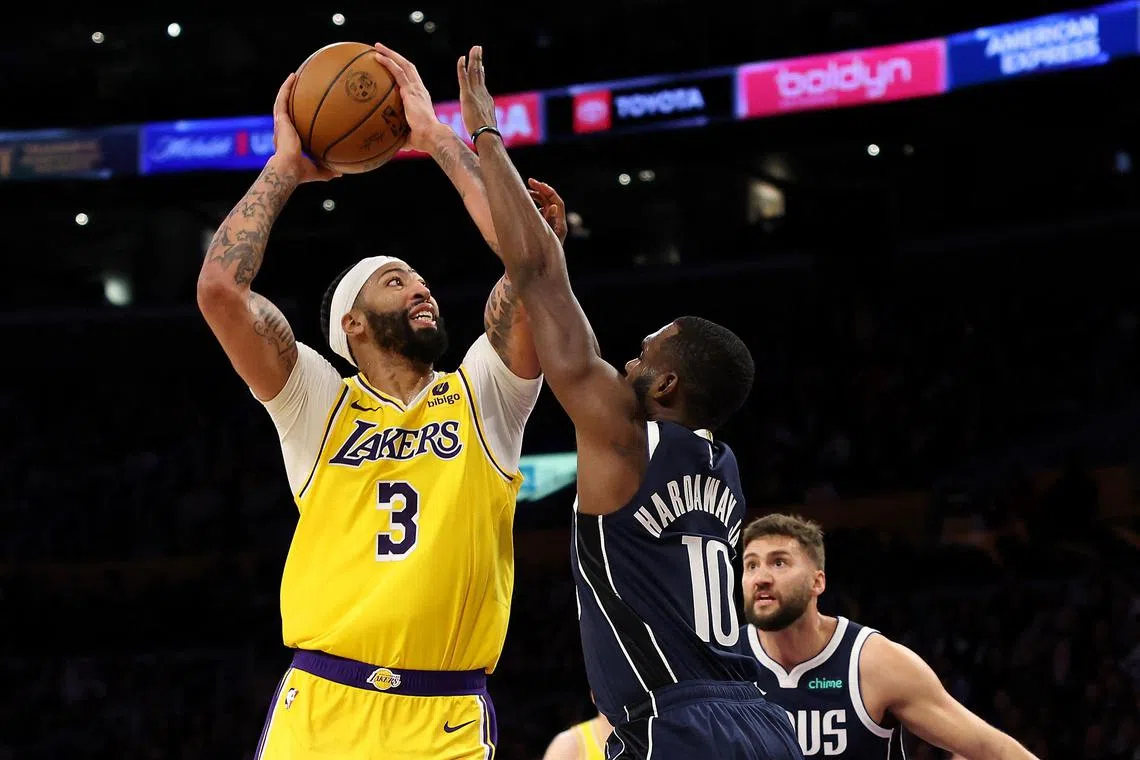 Anthony Davis of the Los Angeles Lakers shoots the ball against Tim Hardaway Jr. of the Dallas Mavericks during the third quarter at Crypto.com Arena.