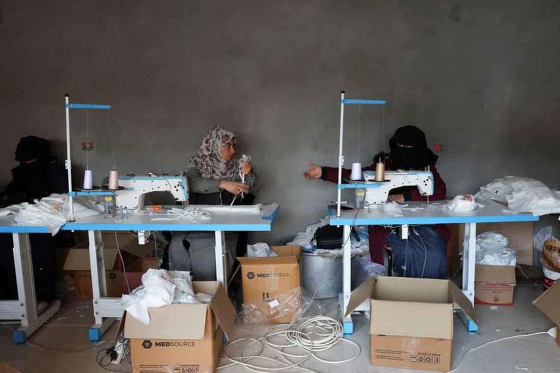 Palestinians sew diapers in a workshop amid scarcity as the conflict between Israel and Hamas continues, in Rafah in the southern Gaza Strip, February 19, 2024. REUTERS/Ibraheem Abu Mustafa