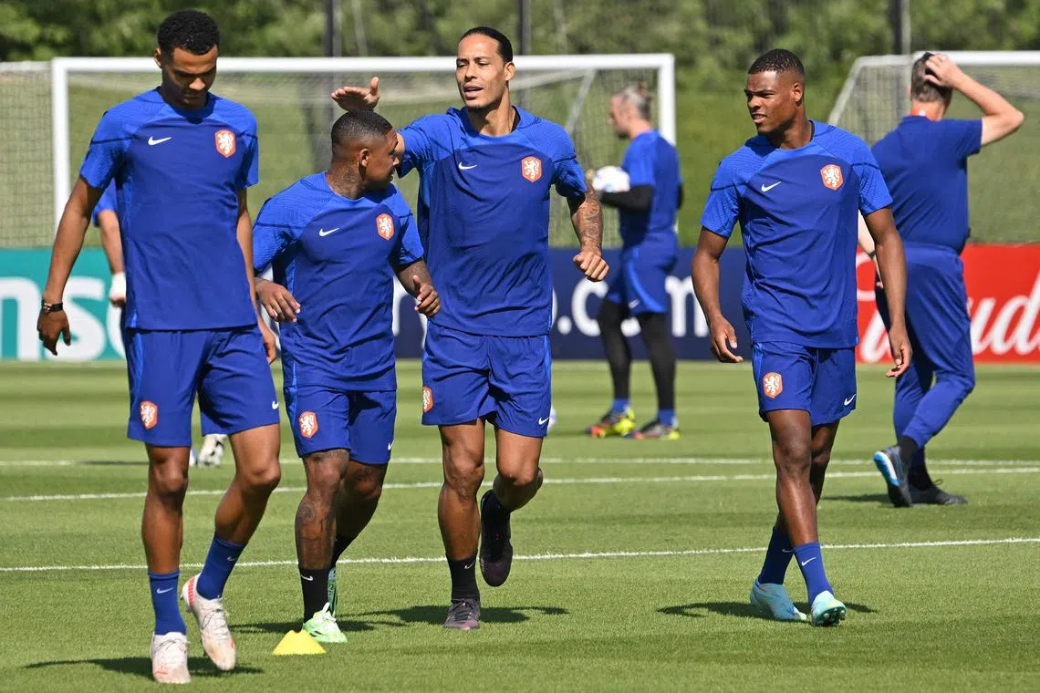 Netherlands players including defender Virgil van Dijk (centre) and forward Steven Bergwijn (second from left) take part in a training session at Qatar Universty in Doha on Nov 24, 2022.