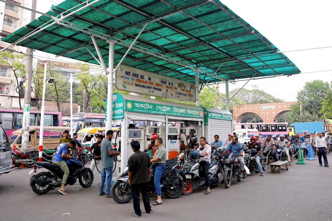 FILE PHOTO: Motorists queue to refuel their motorcycles at a fuel station amid concerns over fuel supply amid the U.S.-Israel conflict with Iran, in Dhaka, Bangladesh, March 15, 2026. REUTERS/Mohammad Ponir Hossain/File Photo