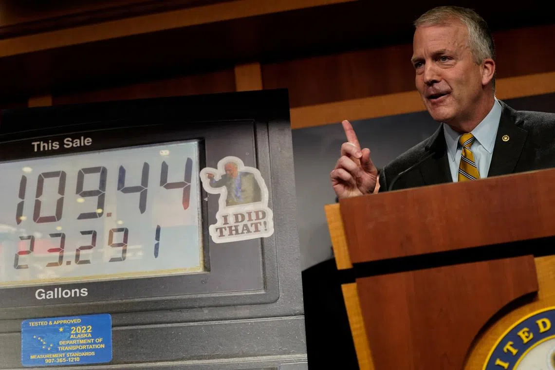 U.S. Senator Dan Sullivan (R-AK) speaks in front of a photo of a gas pump display featuring a sticker of U.S. President Joe Biden, during a press conference about high gas prices for consumers at the U.S. Capitol in Washington, U.S., April 6, 2022. REUTERS/Elizabeth Frantz/File Photo