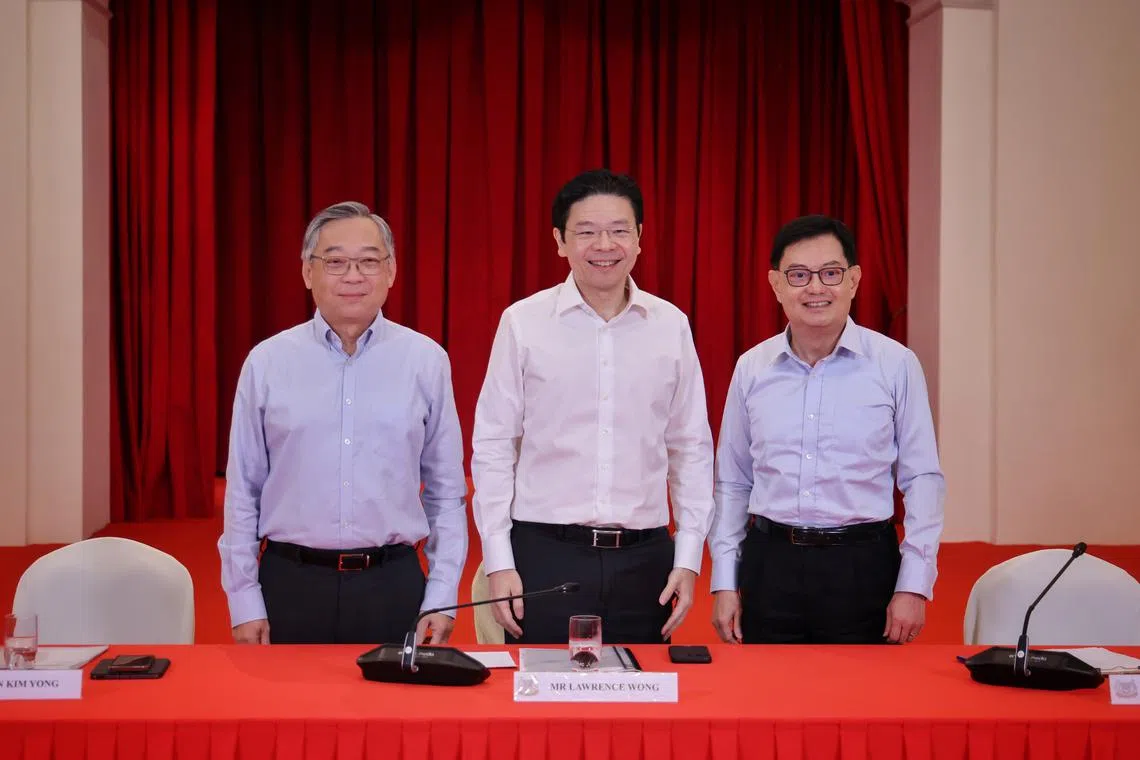 (From left) Minister for Trade and Industry Gan Kim Yong, DPM Lawrence Wong and DPM Heng Swee Keat pose at the Istana after a press conference.