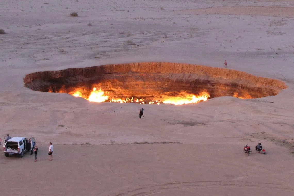 People visiting the "Gateway to Hell", a huge burning gas crater in the heart of Turkmenistan's Karakum desert.
