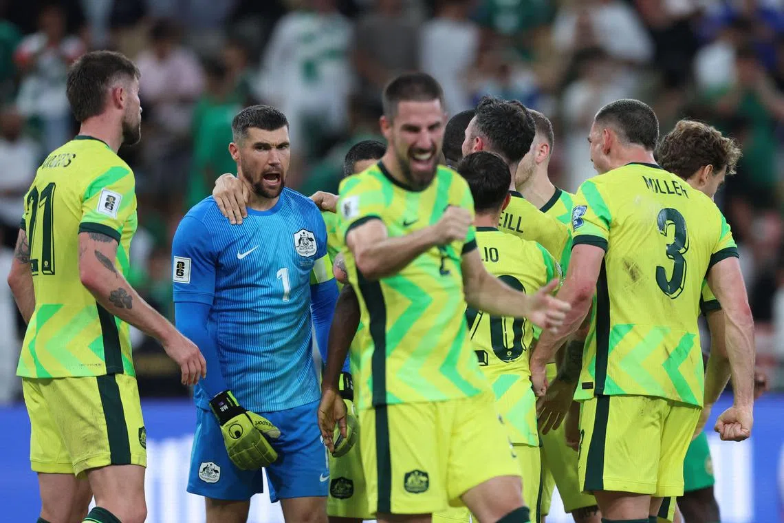 Australia's players celebrate after Saudi Arabia missed a penalty on June 10.