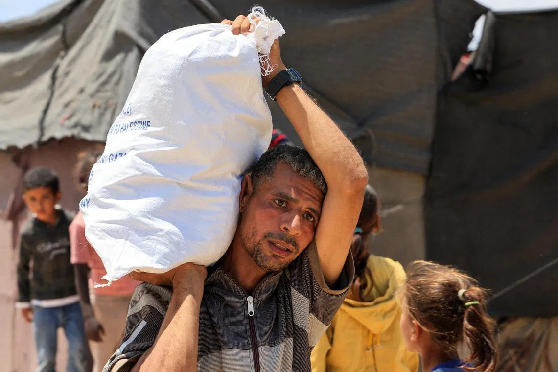 A Palestinian carrying an aid supply he received from the US-backed Gaza Humanitarian Foundation in Khan Younis on May 28. 