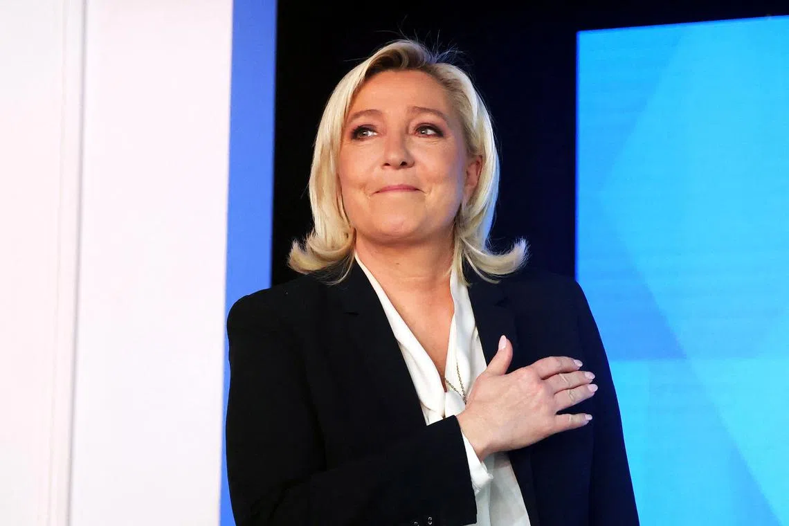 FILE PHOTO: Marine Le Pen, French far-right National Rally (Rassemblement National) party candidate for the 2022 French presidential election, reacts after her defeat in the second round of the 2022 French presidential election, at the Pavillon d'Armenonville, in Paris, France, April 24, 2022. REUTERS/Yves Herman/File Photo