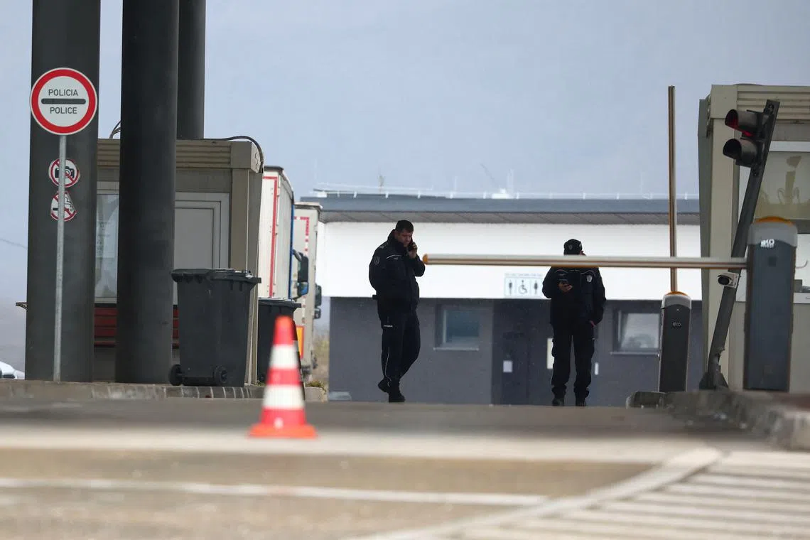 Police officers keep guard at Merdare border crossing between Kosovo and Serbia on Dec 28, 2022.