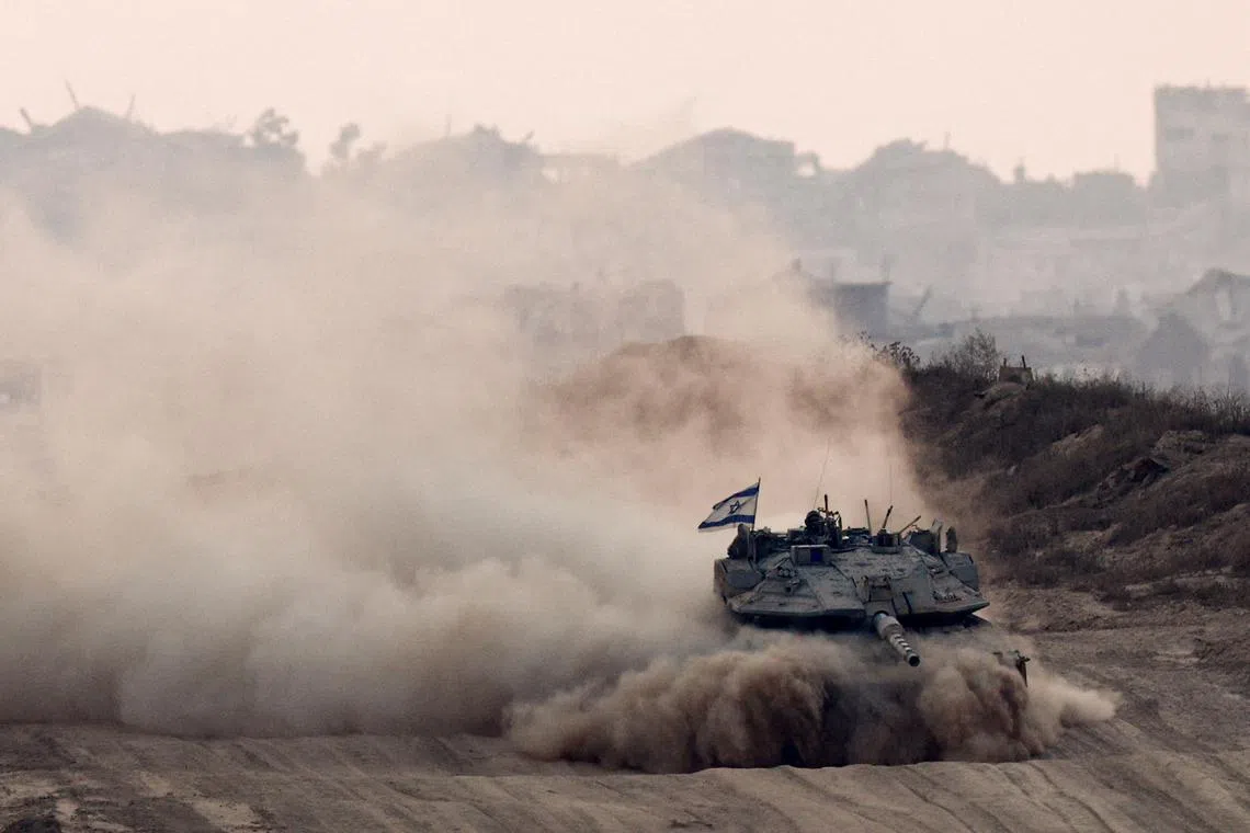FILE PHOTO: An Israeli tank manoeuvres in Gaza, as seen from the Israeli side of the border, June 17. REUTERS/Amir Cohen/File Photo