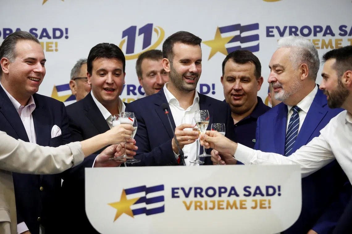 Milojko Spajic, leader of Europe Now Movement, raises the toast with other members of the organisation at the Europe Now Movement's headquarters.