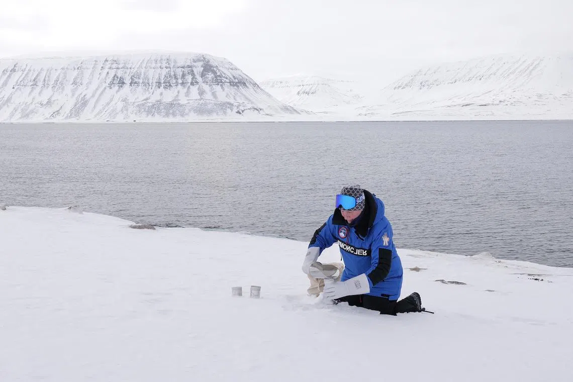 Felicity Aston scoops up snow sample