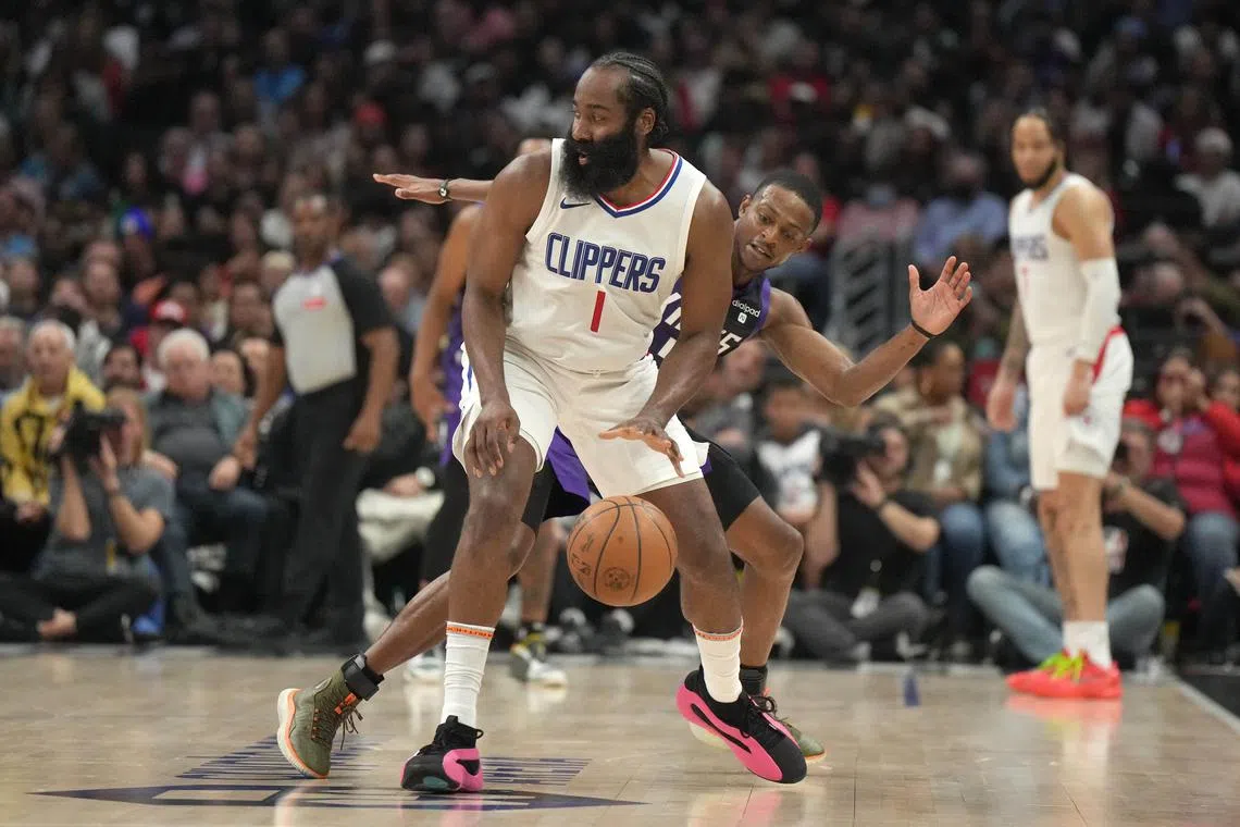 LA Clippers guard James Harden (front) is defended by Sacramento Kings guard De'Aaron Fox in the second half.