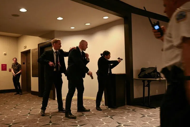 Agents drawing their guns after loud bangs were heard during the White House Correspondents' dinner at the Washington Hilton in Washington DC, on April 25.