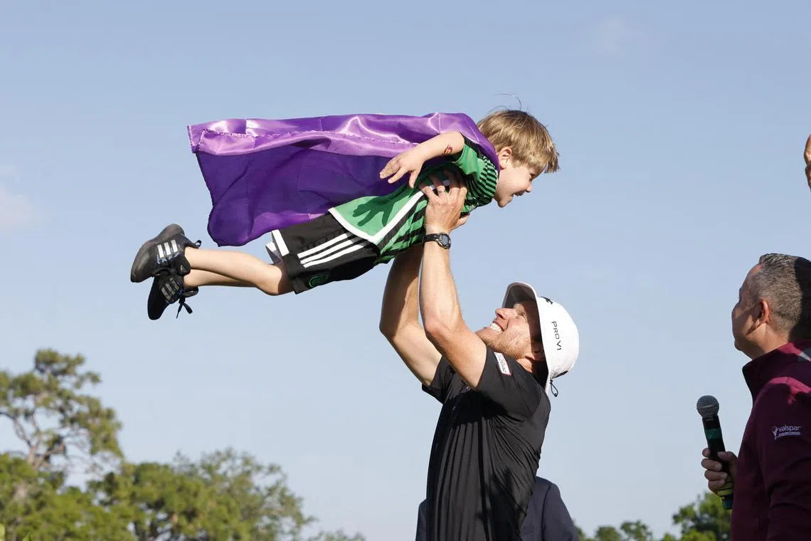 The many moods of a game: Golfer Peter Malnati and his son Hatcher fly high after victory.  