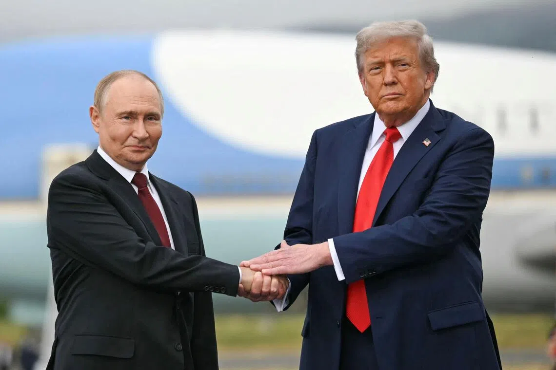 US President Donald Trump greets Russian President Vladimir Putin on the tarmac after they arrived at Joint Base Elmendorf-Richardson in Anchorage, Alaska, on Aug 15, 2025.
