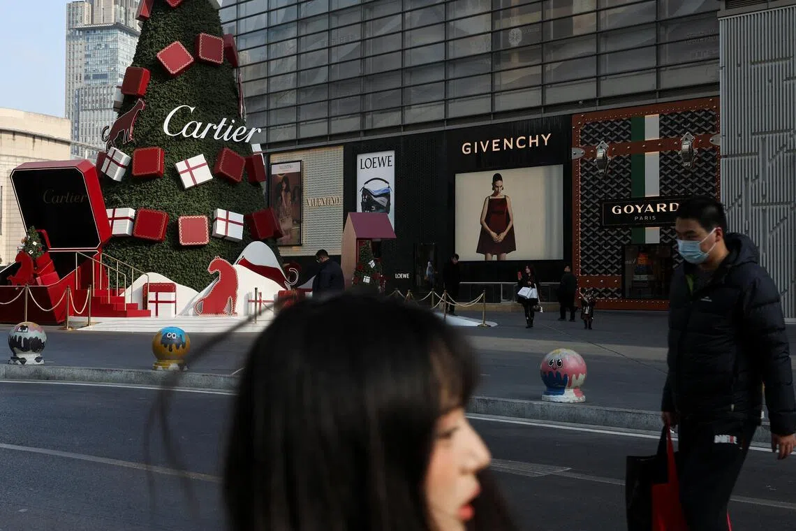 People walk outside of Deji Plaza shopping mall in Nanjing.