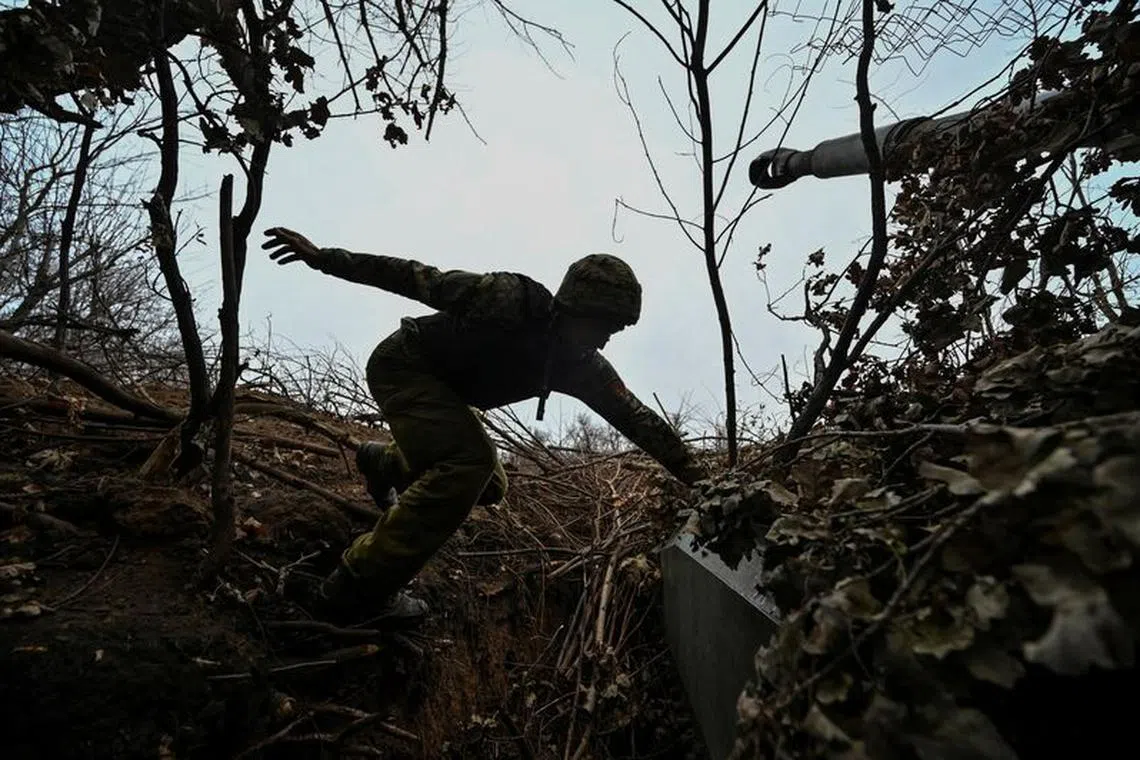 A Ukrainian serviceman jumps on a 2S1 Gvozdika self-propelled howitzer at a position on a front line, amid Russia's attack on Ukraine, in Zaporizhzhia region, Ukraine November 15, 2023. REUTERS/Stringer