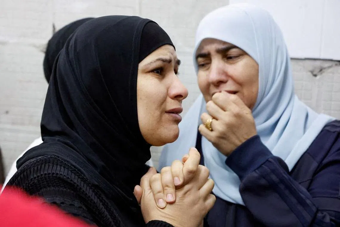 Womean react as they mourn Palestinians who were killed in an Israeli raid, in Tulkarm, in the Israeli-occupied West Bank November 14,2023. REUTERS/Raneen Sawafta