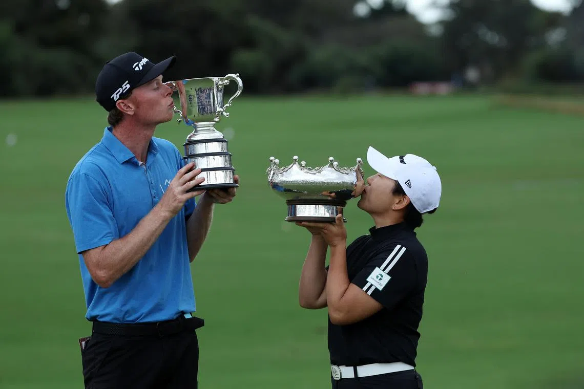 Ryggs Johnston (left) and Shin Ji-yai posing for a photo with their winners trophies at the conclusion of day four of the Australian Open at Kingston Heath Golf Club in Melbourne on Dec 1.