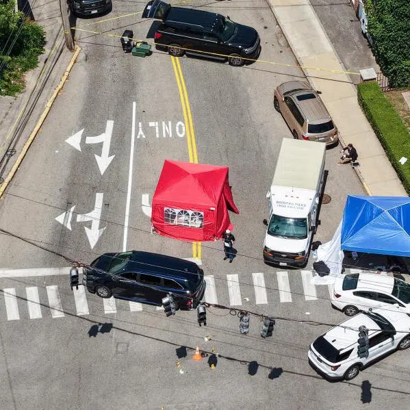 A drone view showing members of law enforcement working at the scene of a shooting involving US Immigration and Customs Enforcement (ICE) in Biddeford, Maine, on July 13, 2026.