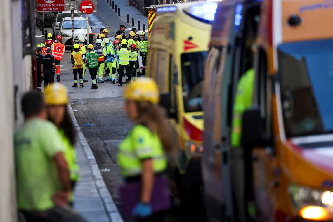 Emergency personnel work at the site of a building collapse in central Madrid, Spain, on Oct 7.