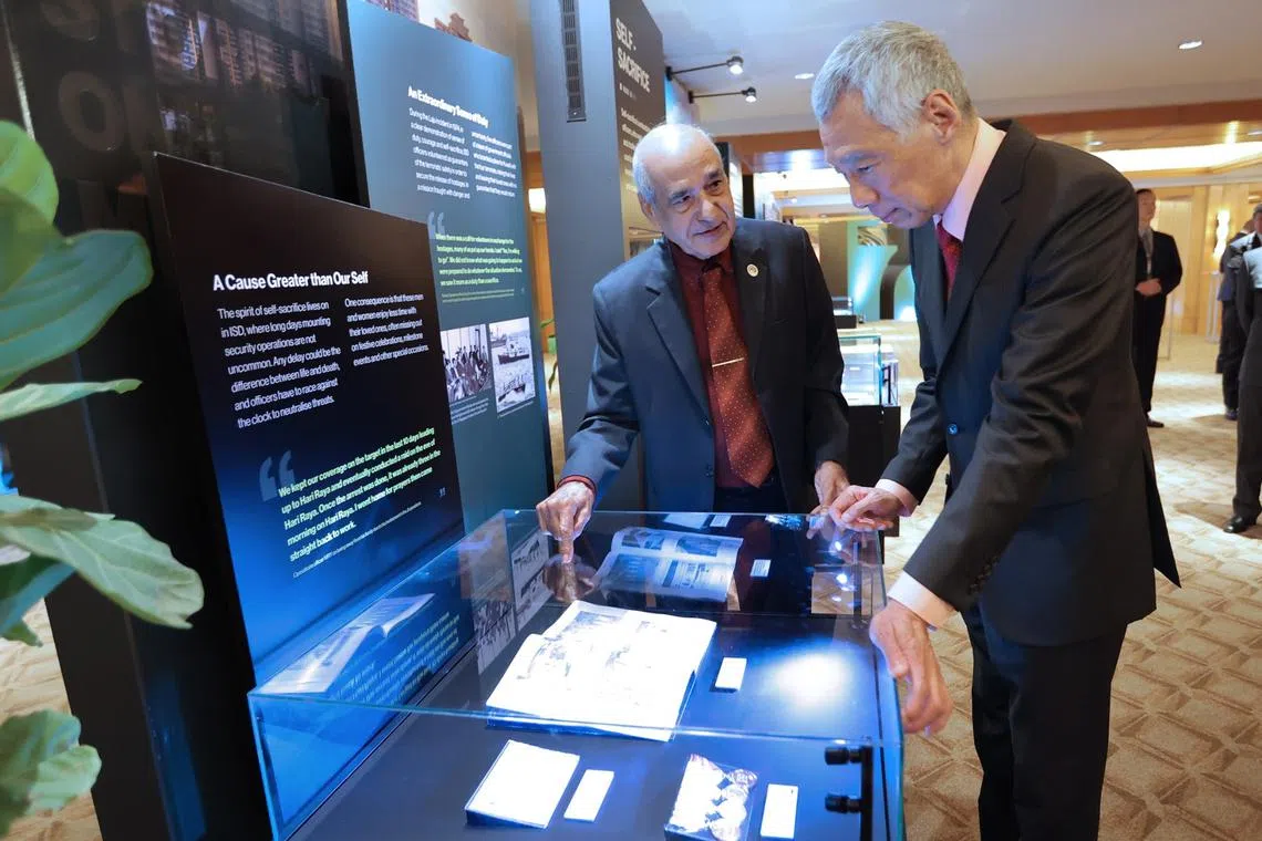 PM Lee Hsien Loong (right) with  Mr Saraj Din, a pioneer ISD officer, at a closed-door event at The Ritz-Carlton, Millenia.