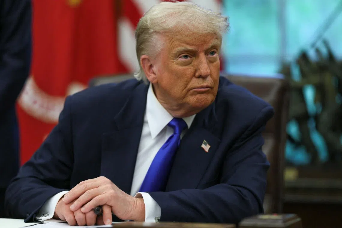 U.S. President Donald Trump looks on as he signs executive orders and proclamations in the Oval Office at the White House, in Washington, D.C., U.S., May 5, 2025. REUTERS/Leah Millis/File Photo