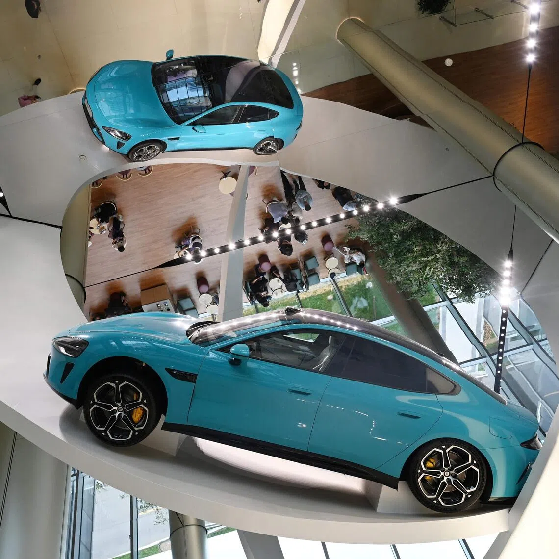 (FILES) A Xiaomi SU7 Max car is displayed at the entrance to the Xiaomi EV Factory, where all Xiaomi EV cars are made, in Beijing on July 1, 2025. Chinese consumer tech giant Xiaomi will remotely fix a flaw in the assisted driving system on over 110,000 of its popular SU7 electric cars, the firm and regulators said on September 19, 2025, months after a deadly crash involving the model. (Photo by GREG BAKER / AFP)