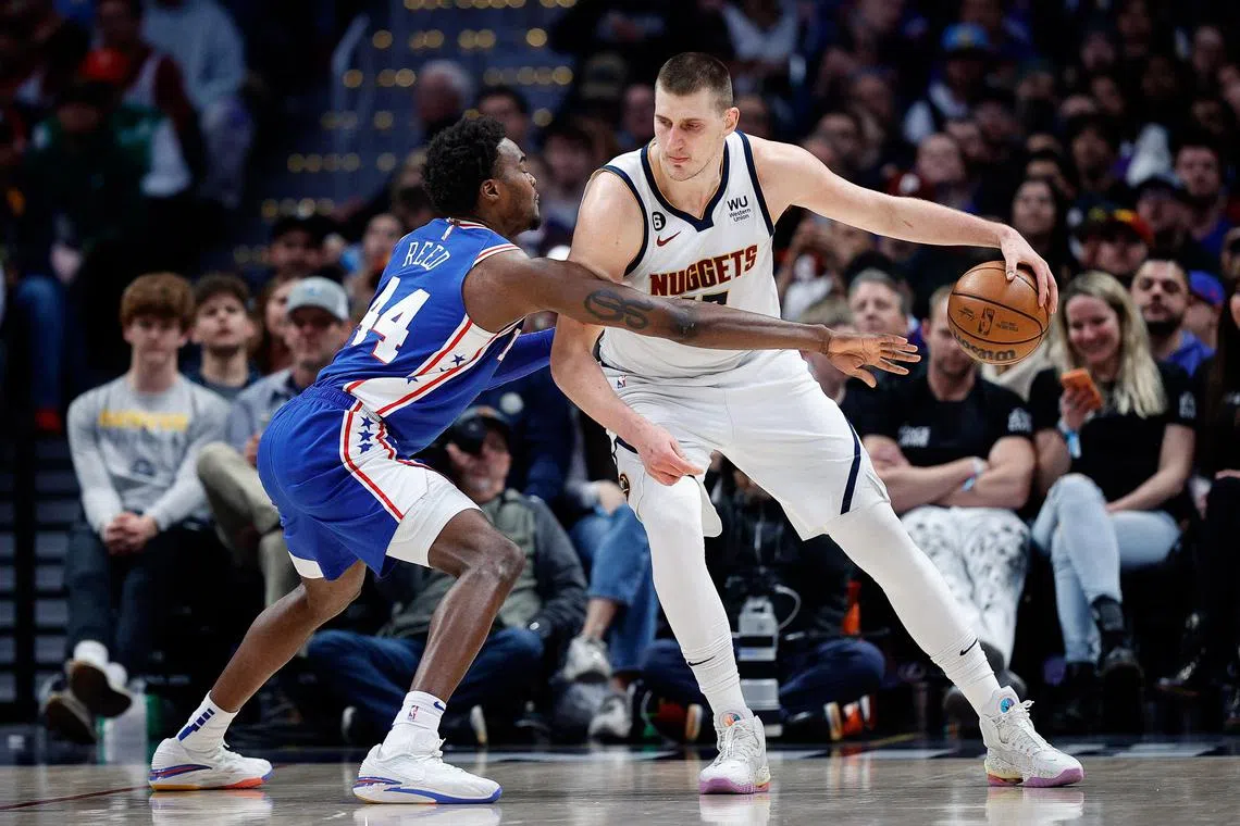 Denver Nuggets centre Nikola Jokic controls the ball as Philadelphia 76ers forward Paul Reed guards in the third quarter at Ball Arena.