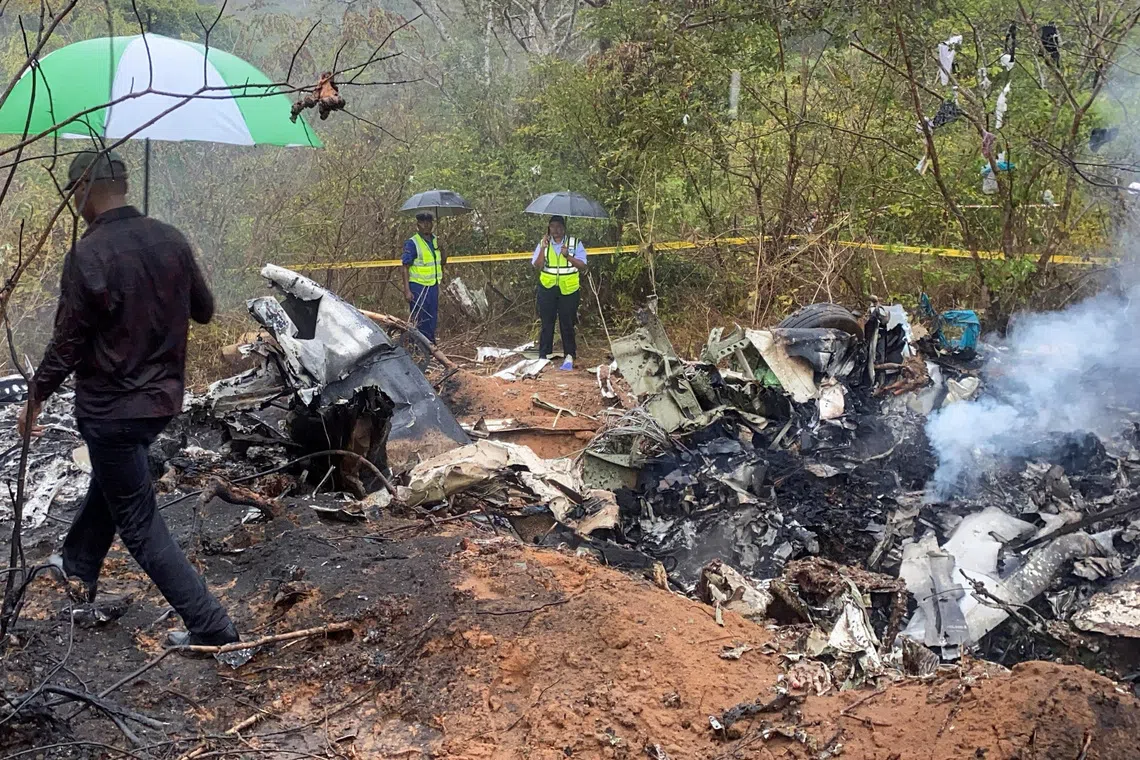 Security officials secure the wreckage of the aircraft 5Y-CCA operated by Mombasa Air Services, which crashed with 12 passengers onboard on its way from Diani to Kichwa Tembo, at the Tsimba Golini area in Kwale County, Kenya, October 28, 2025. REUTERS/Laban Walloga