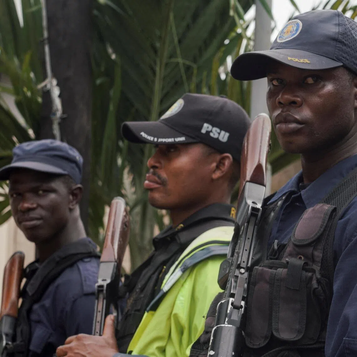 Security guards standing outside a building near Roberts International Airport in Harbel, near Monrovia, on Aug 20, as the arrival of deportees from the US is expected.