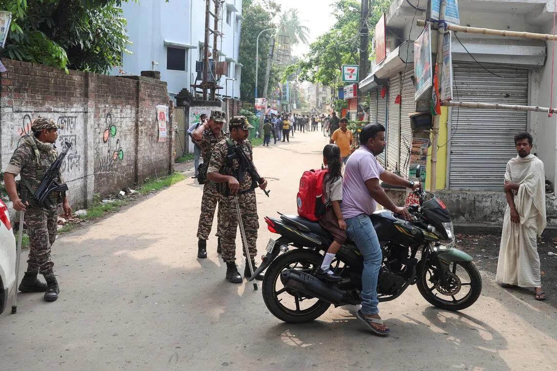 Security forces guard a road leading to the site where an aide of Bharatiya Janata Party (BJP) leader in West Bengal state Suvendu Adhikari was shot dead days after the BJP secured a majority in the state assembly elections.