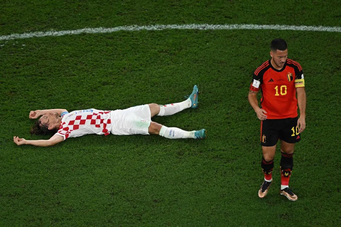 TOPSHOT - Croatia's midfielder #10 Luka Modric (L) and Belgium's forward #10 Eden Hazard react at the end of the Qatar 2022 World Cup Group F football match between Croatia and Belgium at the Ahmad Bin Ali Stadium in Al-Rayyan, west of Doha on December 1, 2022. (Photo by MANAN VATSYAYANA / AFP)