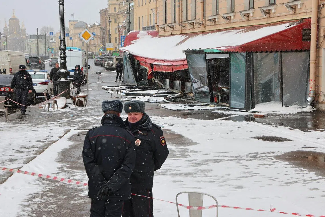Police officers guard a cafe where Russian military blogger Vladlen Tatarsky was killed on April 2, 2023.