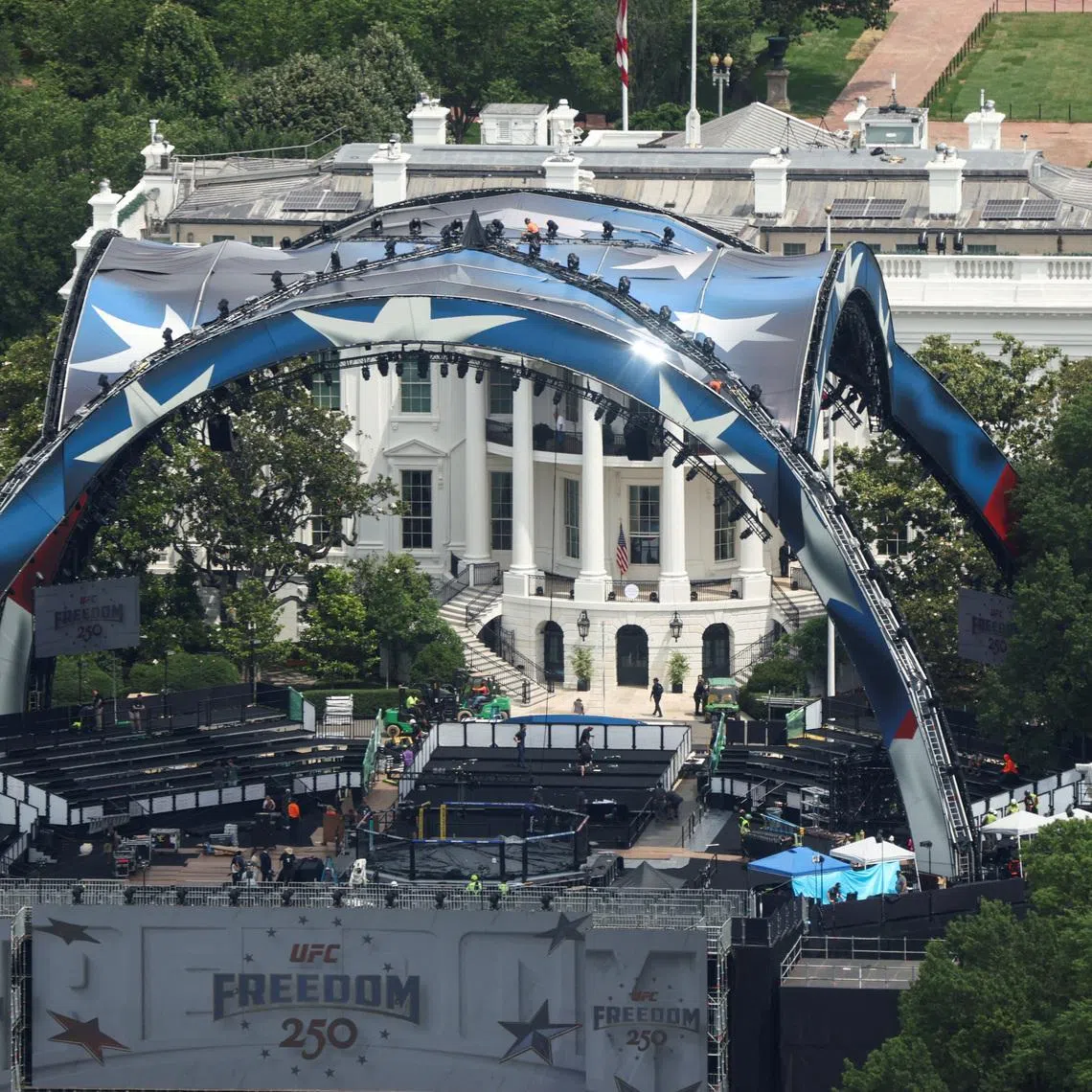FILE PHOTO: Construction continues on a temporary arena that will host the UFC Freedom 250 fight card at the White House in Washington, D.C., U.S., June 9, 2026. REUTERS/Kevin Lamarque/File Photo