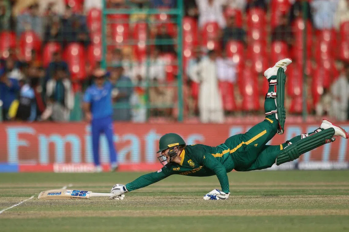 Cricket - ICC Men's Champions Trophy - Group B - Afghanistan v South Africa - National Stadium, Karachi, Pakistan - February 21, 2025 South Africa's Ryan Rickleton dives to avoid a run out REUTERS/Zoral Naik