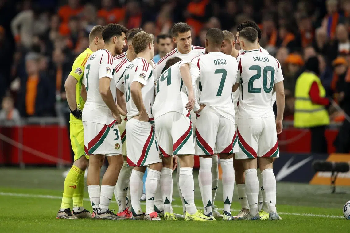 Hungary players in a huddle on the pitch after their assistant coach Adam Szalai suffered a medical emergency. They decided to play on and lost 4-0 to the Netherlands in their Nations League clash.