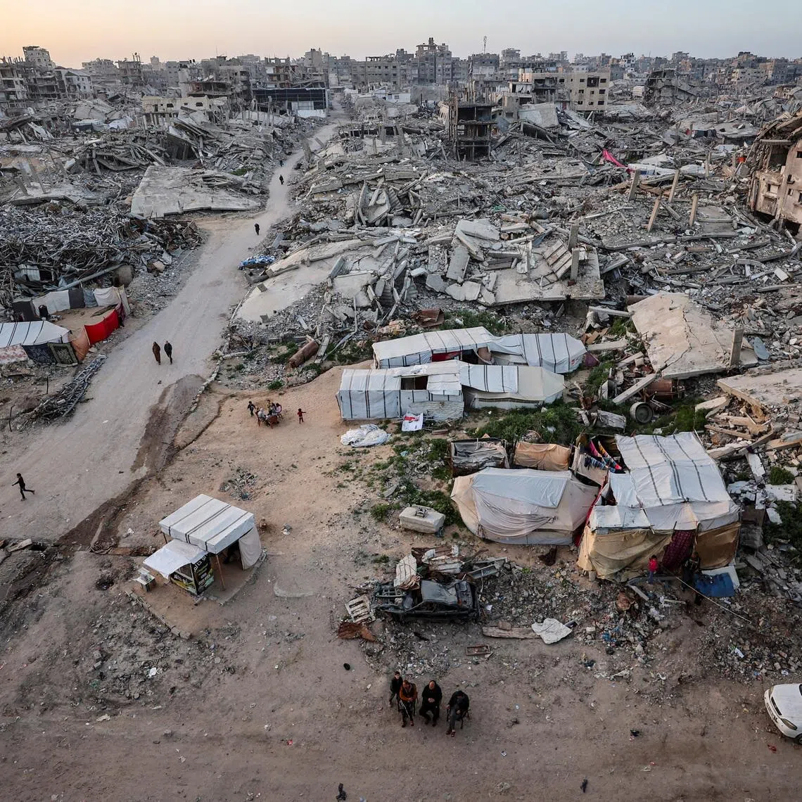 Palestinians gather near the rubble of residential buildings destroyed during the two-year Israeli offensive, on the first day of the holy month of Ramadan, in Gaza City, February 18, 2026. REUTERS/Dawoud Abu Alkas/File Photo