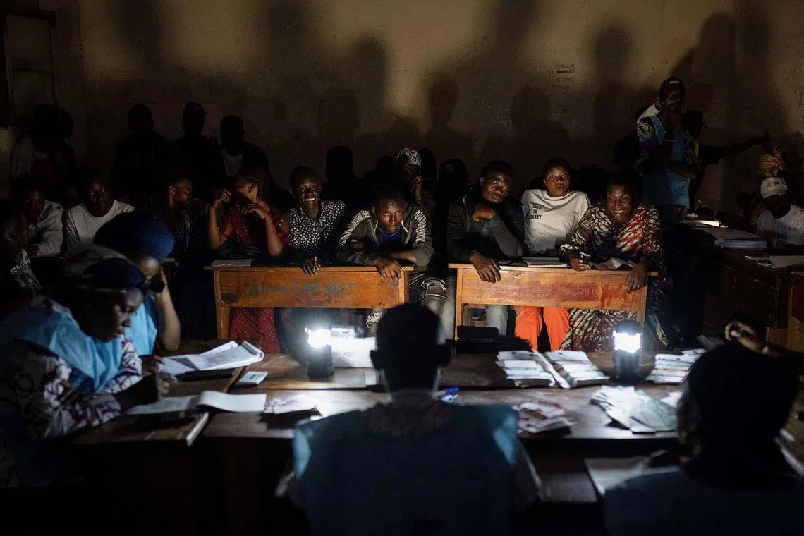 Independent National Electoral Commission (CENI) officials and polling agents gather to count and tally casted ballot papers at a polling centre following the Presidential election in Goma, North Kivu province of the Democratic Republic of Congo, Dec 20, 2023. 