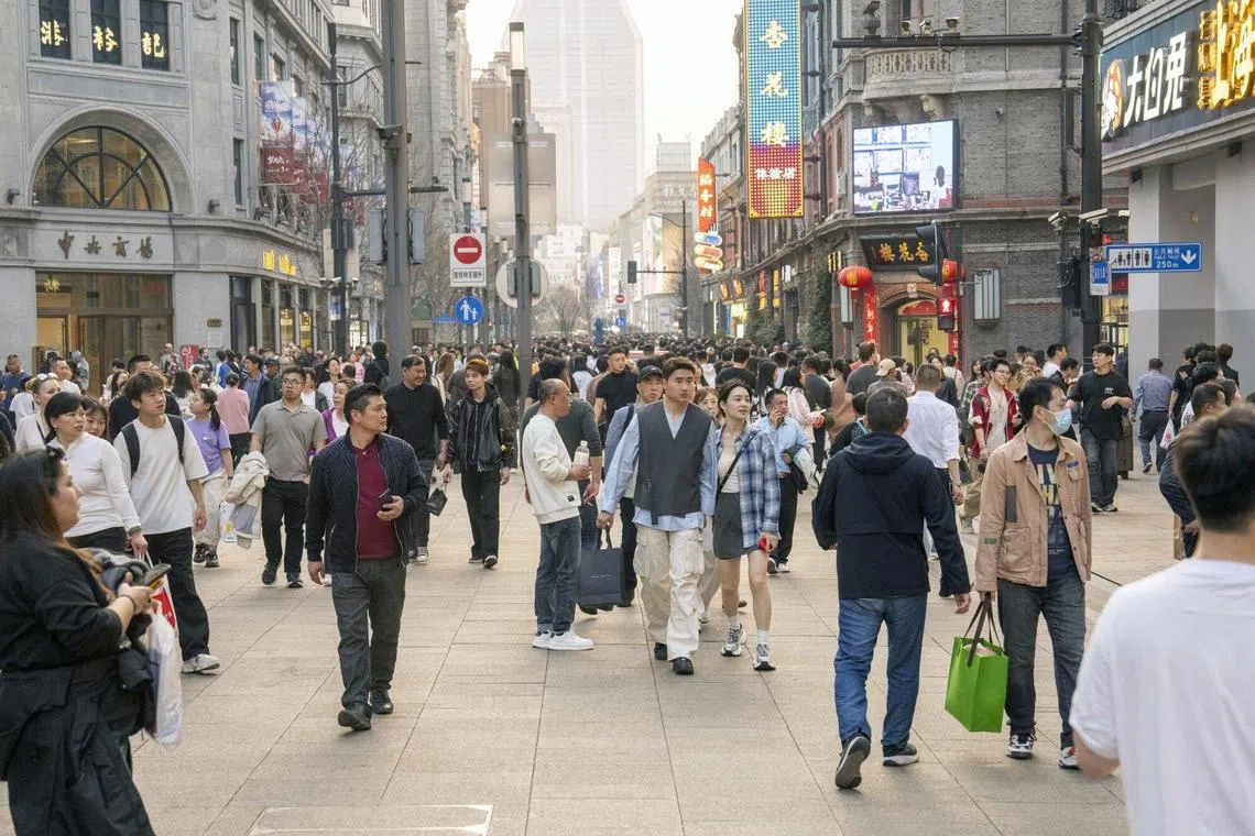 Shoppers in the Nanjing Road West shopping area in Shanghai, China, on Sunday, March 2, 2025. President Xi Jinping heads into China's biggest political huddle of the year with his economy finally getting back some swagger. Photographer: Raul Ariano/Bloomberg