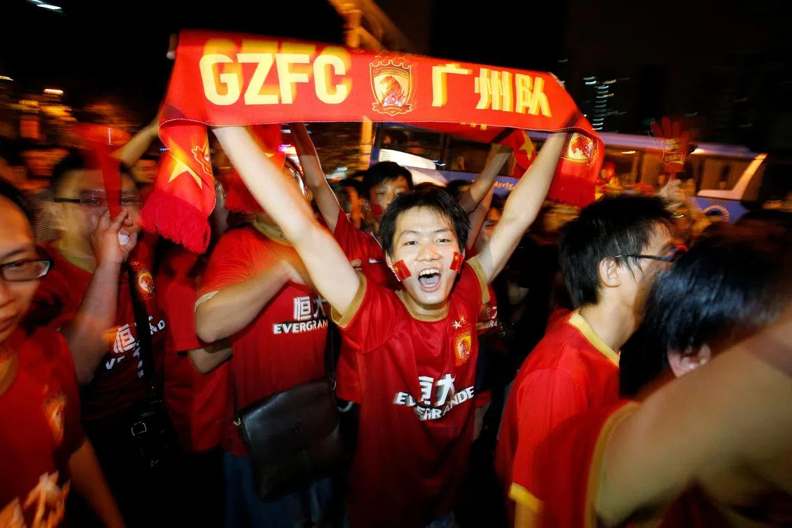China's Guangzhou Evergrande fans celebrate after their team won the final match of the AFC Champions' League against South Korea's FC Seoul at Tianhe stadium in the southern Chinese city of Guangzhou, November 9, 2013. REUTERS/Bobby Yip/ File Photo