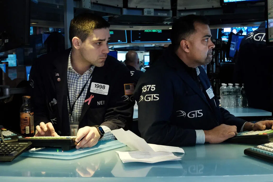 Traders work on the floor during morning trading at the New York Stock Exchange, on March 10, 2023 in New York City.