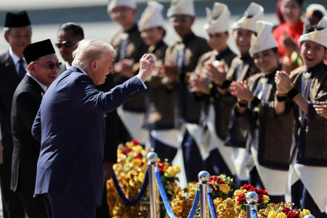 U.S. President Donald Trump joins the performers in a dance during a welcoming ceremony after arriving at Kuala Lumpur International Airport, to attend the 47th Association of Southeast Asian Nations (ASEAN) Summit, in Kuala Lumpur, Malaysia October 26, 2025. REUTERS/Hasnoor Hussain/Pool