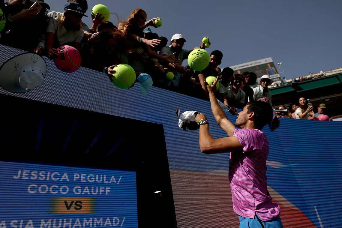 Carlos Alcaraz of Spain signs autographs after his match against Fabian Marozsan of Hungary during the BNP Paribas Open at Indian Wells.