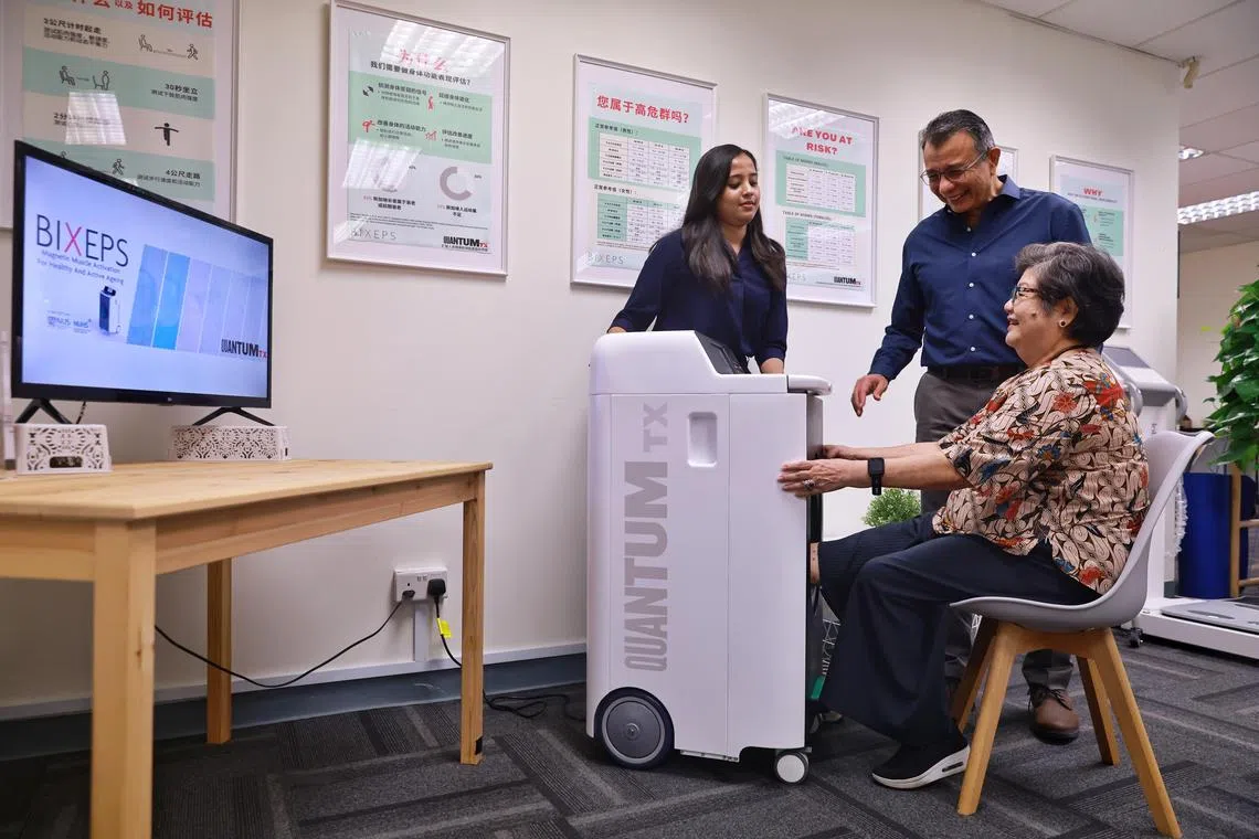 Mrs Yvette Cheak (R), 73, retiree, poses for a photo with Ms Sharanya Venugobal (L), clinical research coordinator at QuantumTX; and Associate Professor Alfredo Franco-Obregon (C), principal investigator with NUS iHealthtech, while using the Bixeps device, on May 23, 2023.