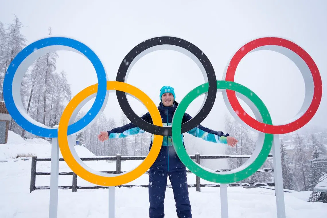 Feb 4, 2026; Cortina d'Ampezzo, ITALY; Cesare Marchedde of Balogna Italy poses for a photo in front of Olympic rings ahead of the Milano Cortina 2026 Olympic Winter Games at the Cortina Sliding Centre. Mandatory Credit: Michael Madrid-Imagn Images